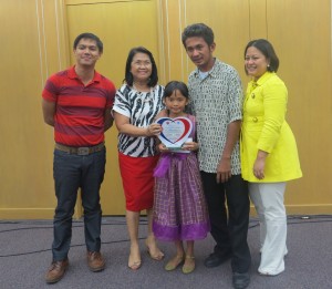 Jairuz of Abra Province receives her award together with her father and RPC Irene Bungay