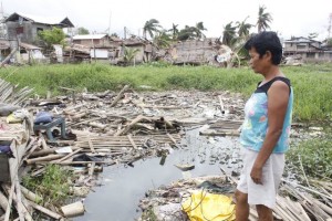 Elizabeth visiting the site where her home stands before the onlsaught of Typhoon Yolanda. Nothing was left but the ruins.