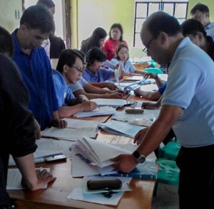 Together, community volunteers and members of the local government unit scrutinize the sub-project proposals from the barangays before the final selection of priority projects through the Municipal Interbarangay Forum for Participatory Resource Allocation. (Photo by Benjie Bing-il)