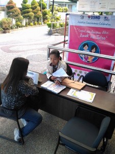 Social Worker Metzi Aglayen attends to the queries of a possible adoptive parent in one of the adoption inquiry desks set up in different Government Agencies in Baguio City. The desks are part of the Adoption Consciousness Month Celebration of DSWD-CAR. It aims to increase the awareness of the public on adoption and foster care.